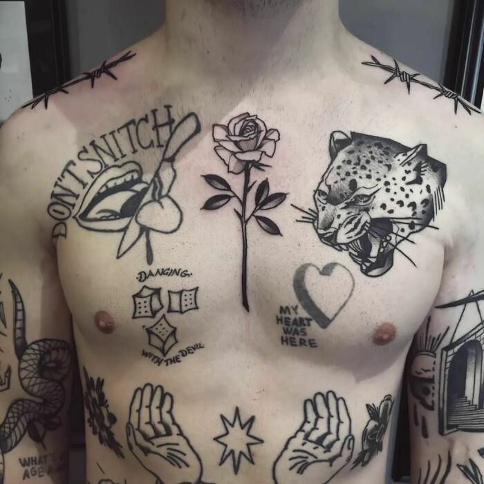 Man's chest with patchwork tattoo designs including a rose, leopard, and various symbols.