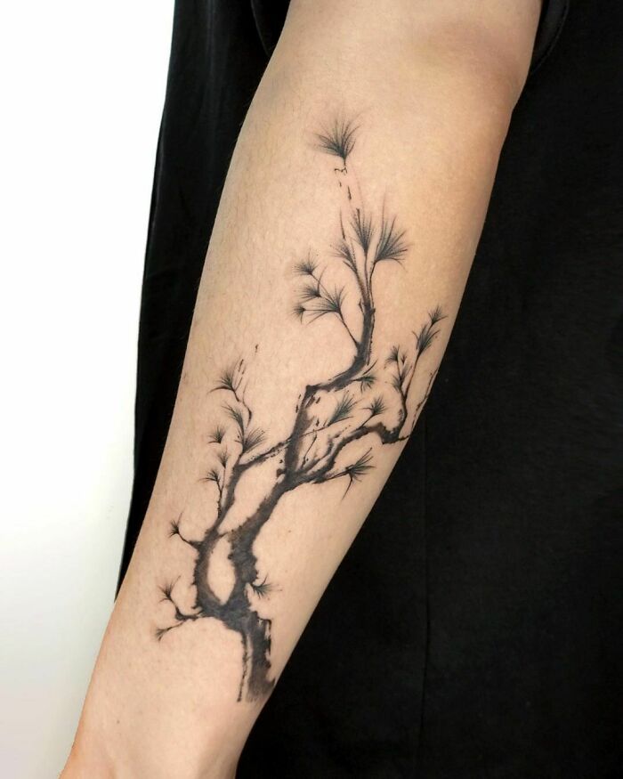 Tree tattoo on forearm with intricate branches, celebrating nature’s beauty.