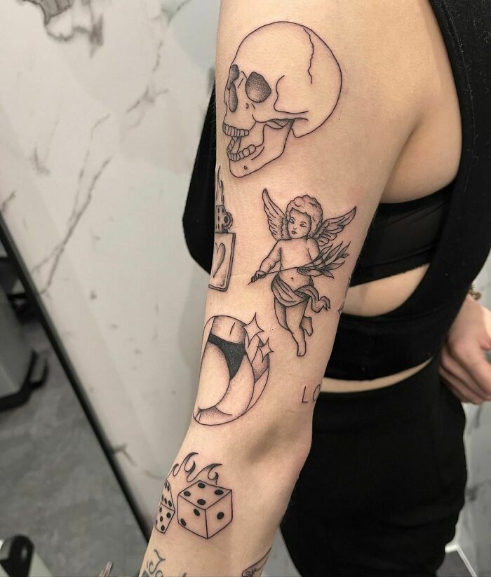 Patchwork tattoo on arm featuring a skull, cherub, and dice design.