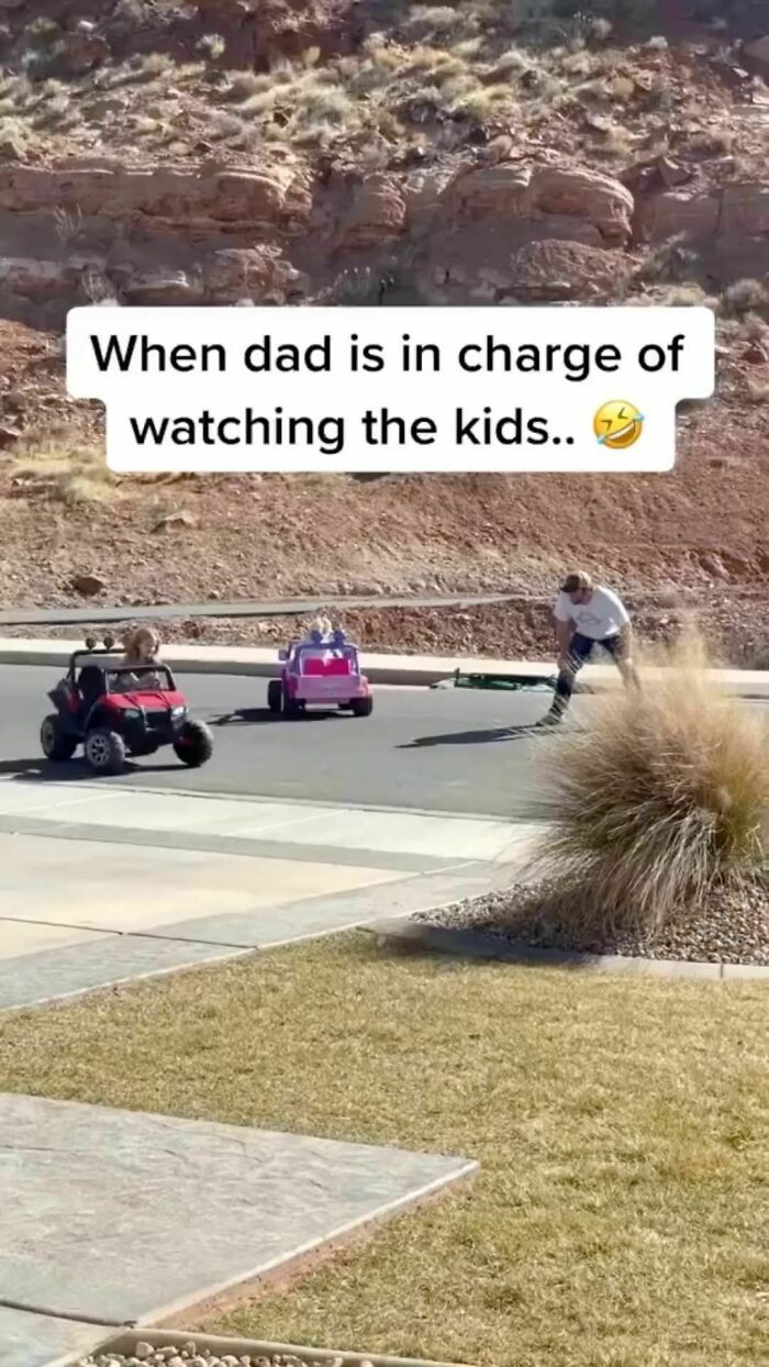 Dad supervising kids in toy cars on a sunny day, showcasing classic dad moves.