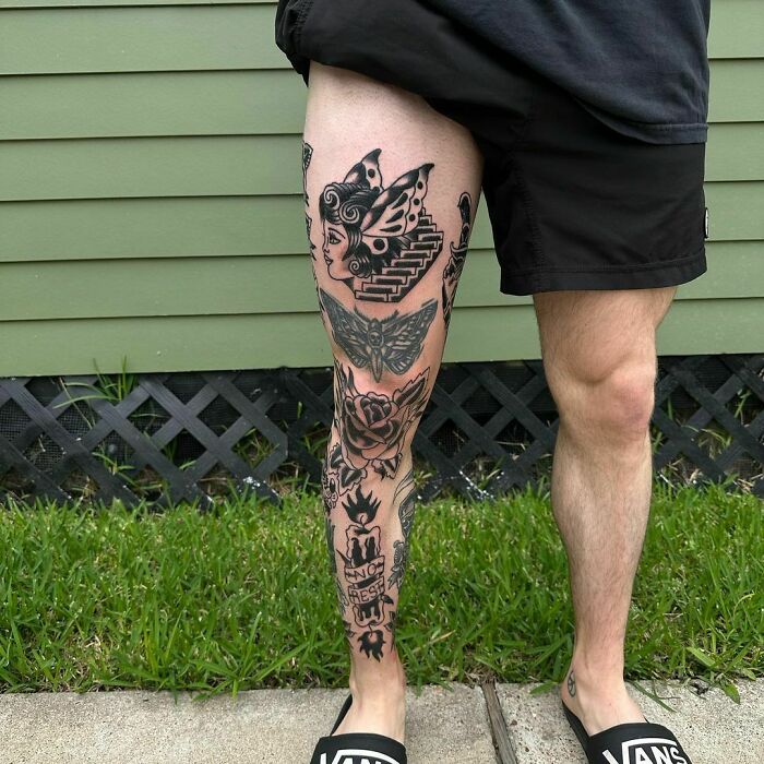Male leg with patchwork tattoos, featuring a face, butterfly, and rose, showcasing unique tattoo designs.