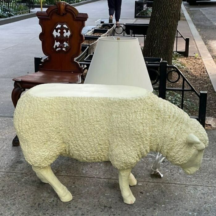Sheep-shaped table and lamp discarded on NYC sidewalk as an unexpected treasure found in the city streets.