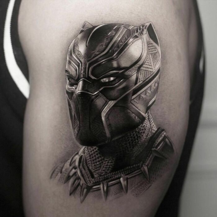Pop culture tattoo of a highly detailed, realistic Black Panther design on an upper arm.