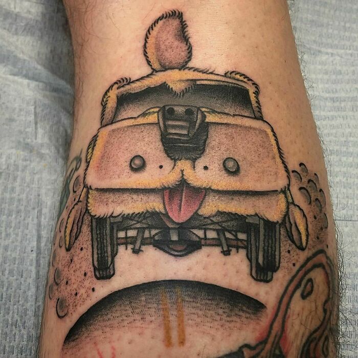 Unique pop culture tattoo of a furry van with a tongue sticking out, depicting a playful and creative design.