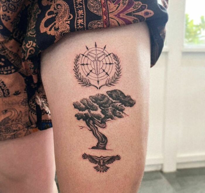 Tattoo of a majestic tree with a geometric symbol above and a bird below, celebrating nature's wonders.