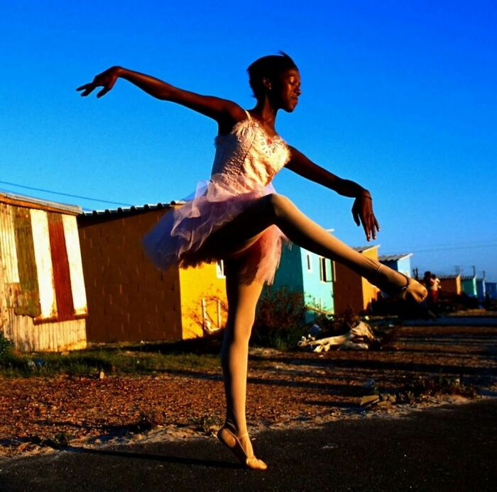 Noluyanda Mqutwana Dances Outside Her Two-Room Family Shack In Khayelitsha, One Of The Poorest Black Townships Outside Cape Town (South Africa 2000)