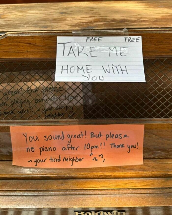 Wooden Baldwin piano with notes saying take me home free and a neighbor requesting no piano after 10pm in NYC treasures.