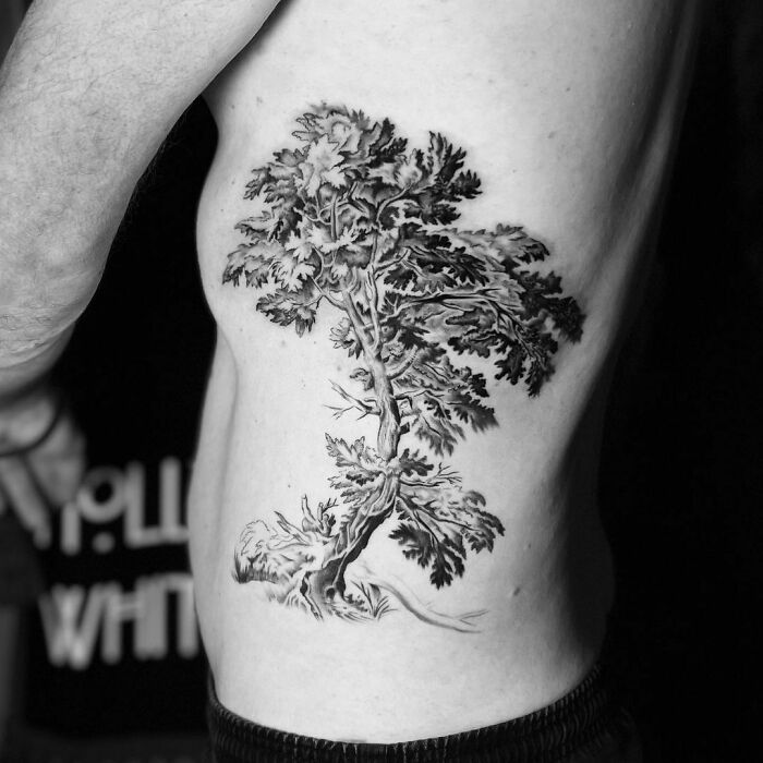 Tree tattoo on a person's side, showcasing intricate branches and leaves, celebrating nature's wonders in art.