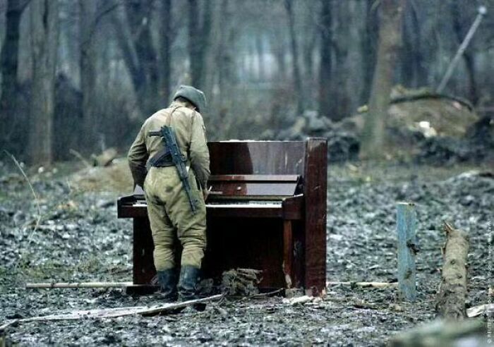 A Russian Soldier Playing An Abandoned Piano In Chechnya, 1994