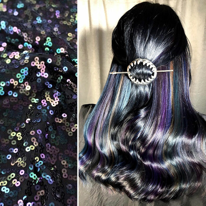 Woman with long, wavy hair featuring colorful highlights and a decorative hair clip, showcasing new hair designs.