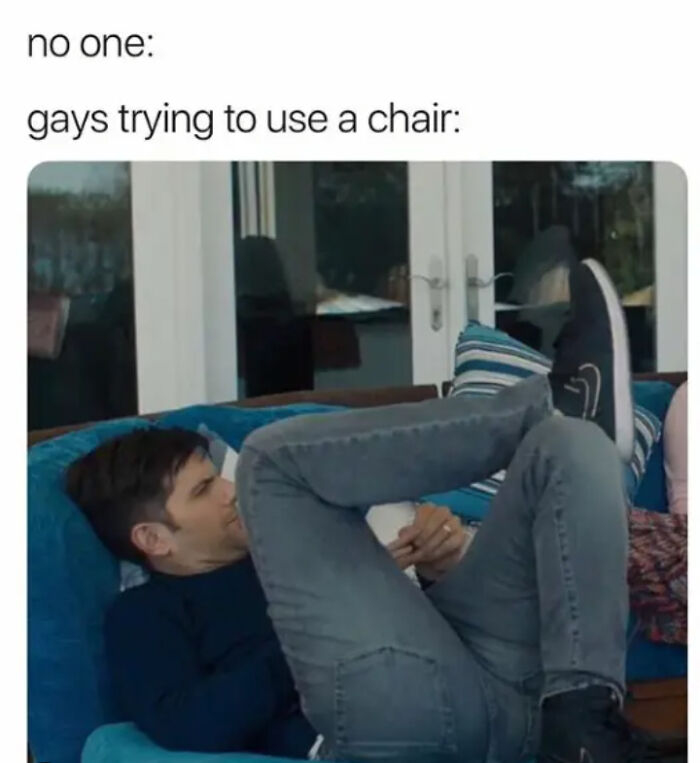 Person humorously lounging on a sofa, referenced in a Pride Month meme about using a chair, wearing casual attire.