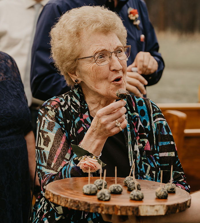 Elderly woman enjoying a bite, embodying wisdom and the spirit of funny and naughty advice from grandparents.