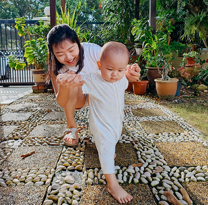 Woman smiling and walking with child outdoors, capturing moments of wise and funny advice from grandparents.