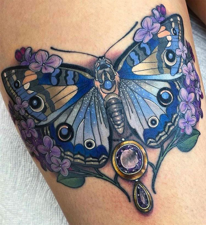 Colorful butterfly tattoo with purple flowers and intricate details.