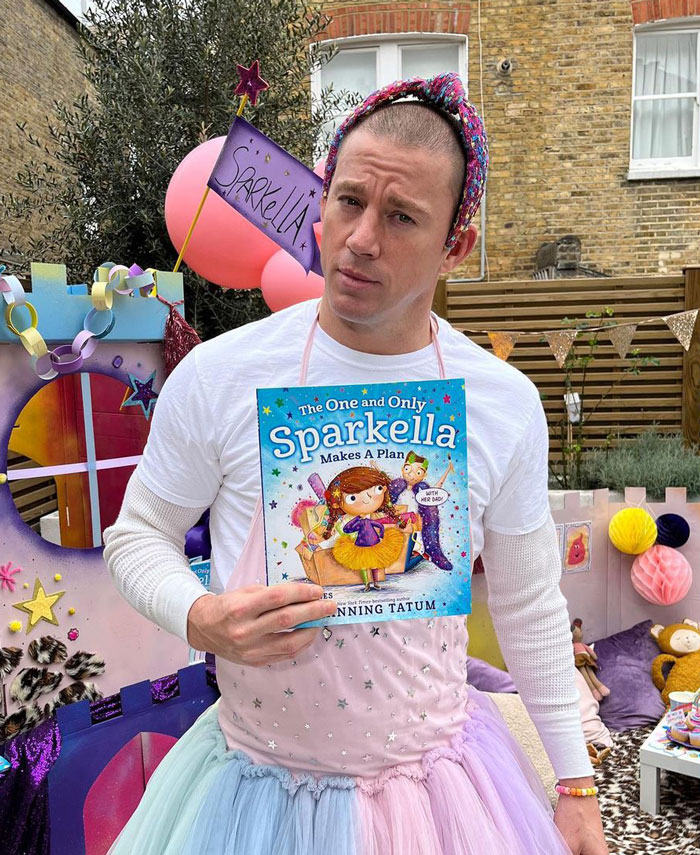 Channing Tatum dressed as a girl and holding a a kid's book 