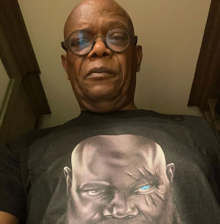 Man with glasses looking down 