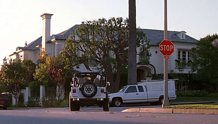 White car passing through the Stop sign 