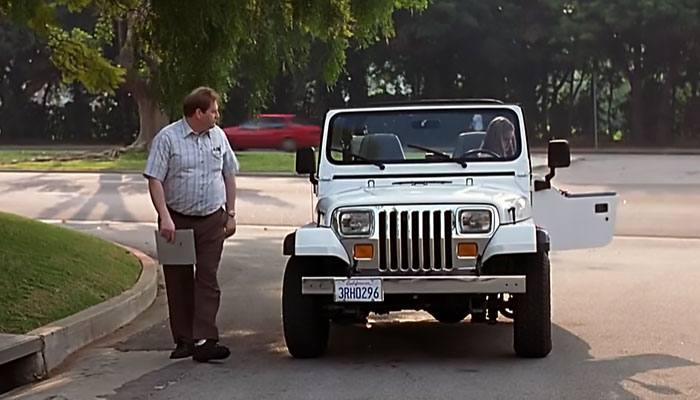 Cher driving white car 