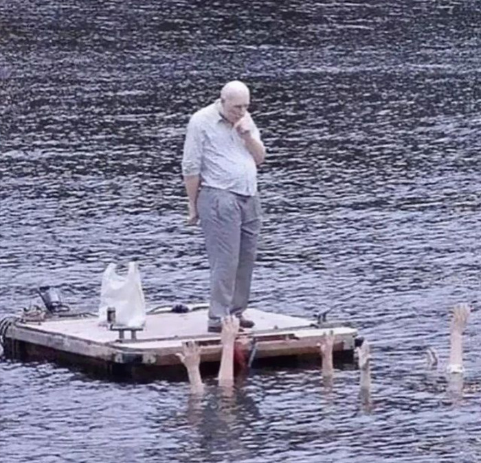 Cursed meme of a person on a platform watching hands reaching from water.