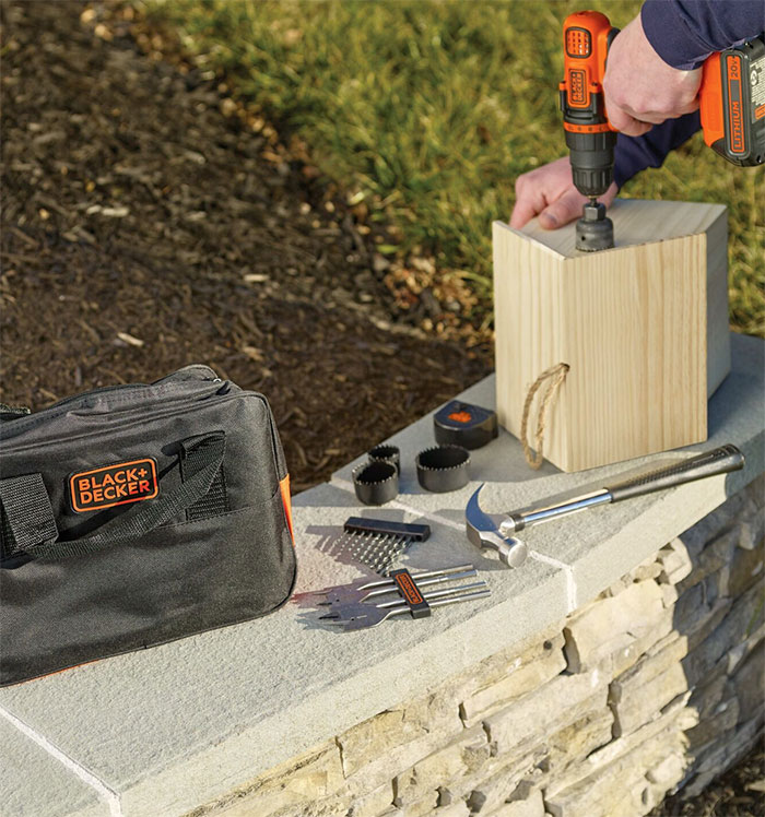Man drilling a wooden block 