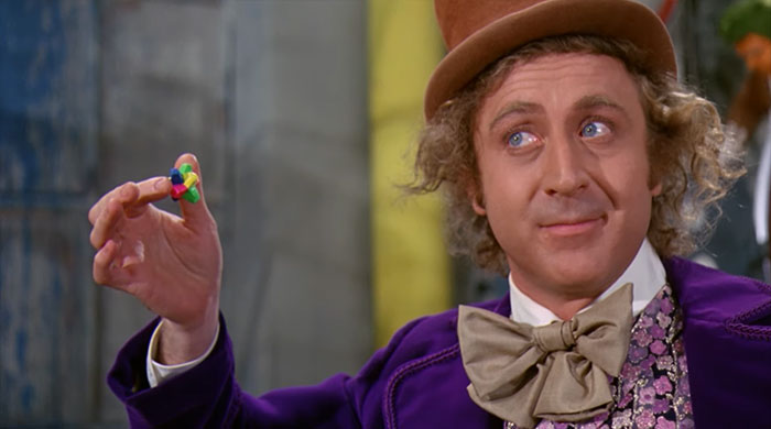 W***y Wonka holding a piece of chewing gum