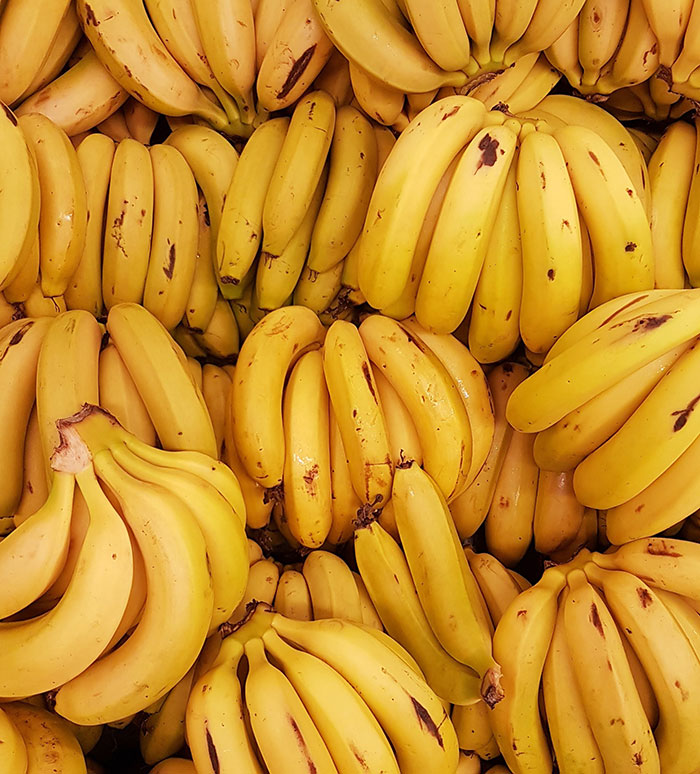 A large pile of ripe yellow bananas, often a subject in food history facts.