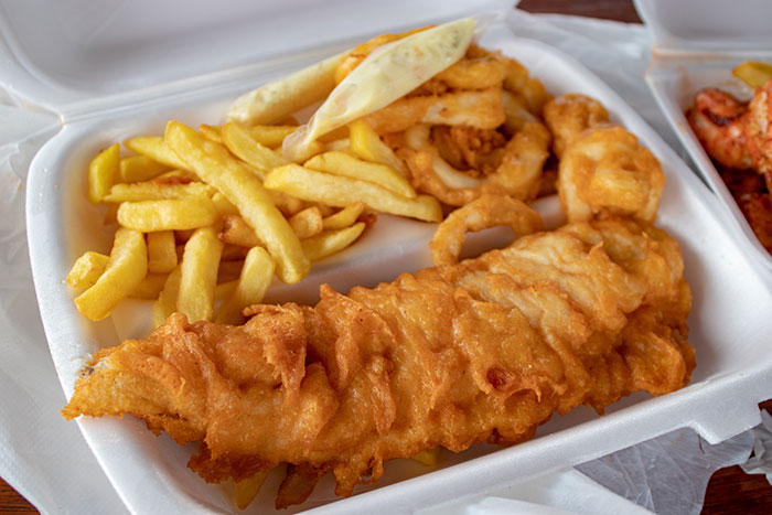 Classic fish and chips in a takeaway container, showcasing fascinating food history facts.