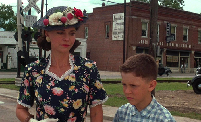 Mrs. Gump and young Forrest dressed in vintage attire, a scene capturing iconic Forrest Gump quotes and moments.