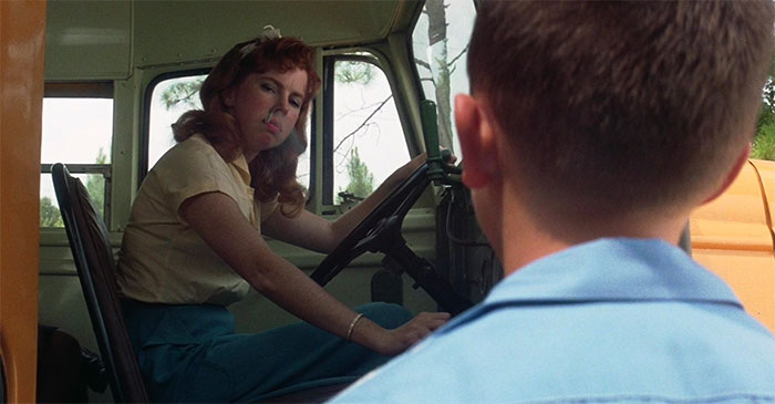Forrest Gump talking to a school bus driver inside the bus, capturing a moment from iconic Forrest Gump quotes.
