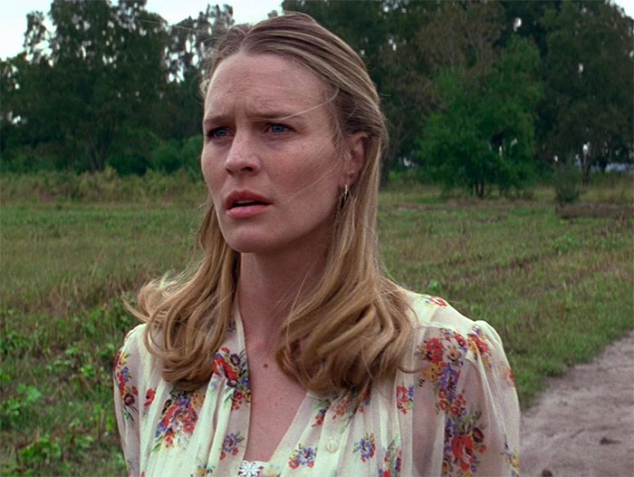 Jenny from Forrest Gump wearing a flower print dress standing outdoors in a natural green rural setting forrest gump quotes