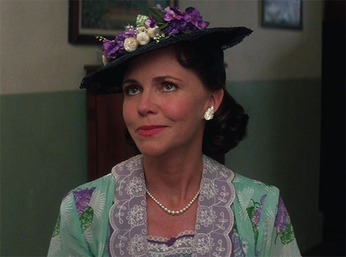 Mrs. Gump wearing a floral hat and vintage dress, a classic character from Forrest Gump quotes collection.