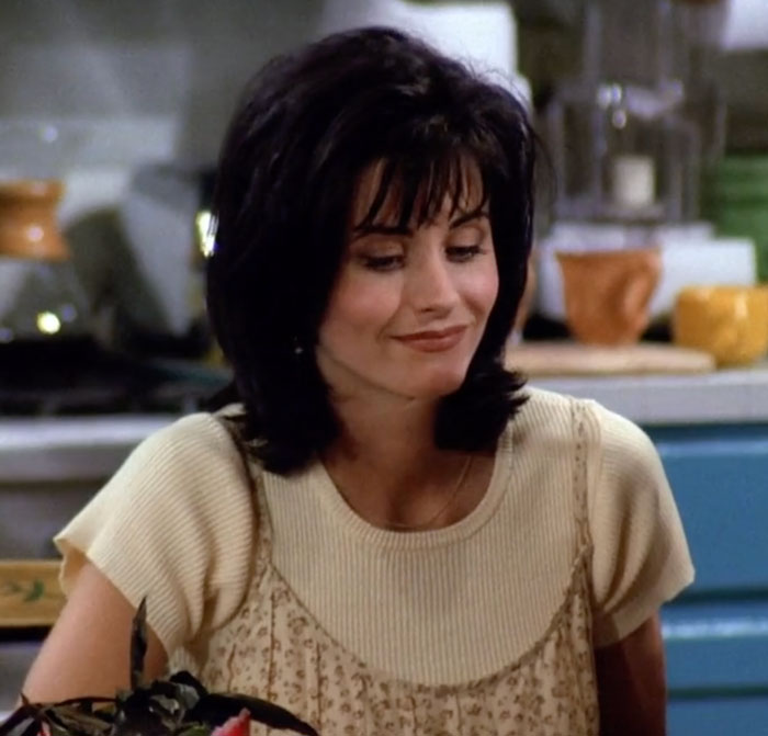 Monica wearing beige t-shirt 