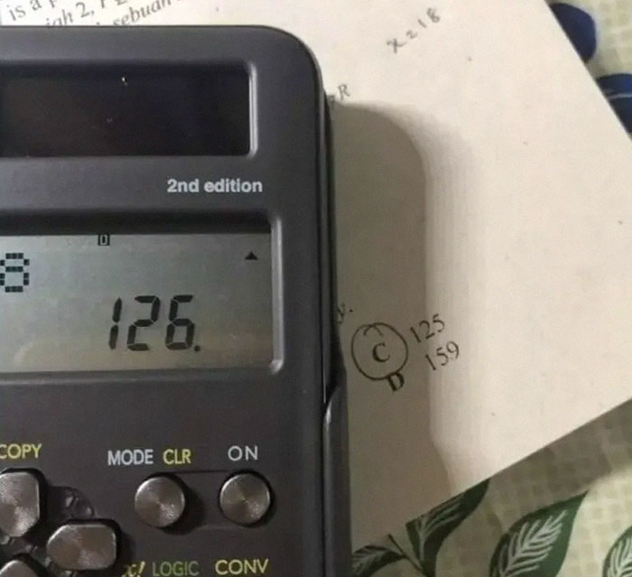 A calculator displaying 126, next to a test question marked with educational memes humor.