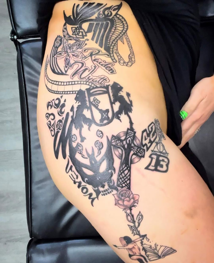 Large tattoo fail on thigh featuring overlapping black ink designs including skulls, crosses, numbers, and abstract shapes.