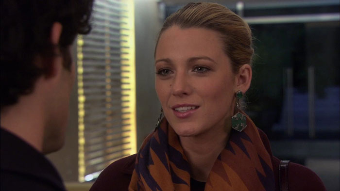 Serena wearing scarf and green earrings 