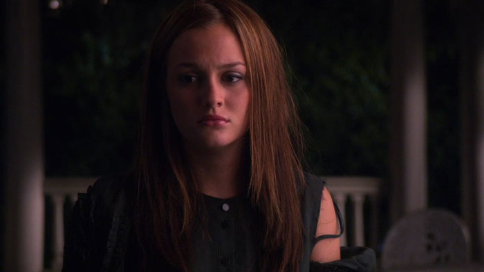 Blair wearing black dress with messy hair 