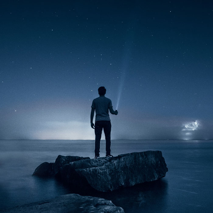 Man on a rock in a beach 