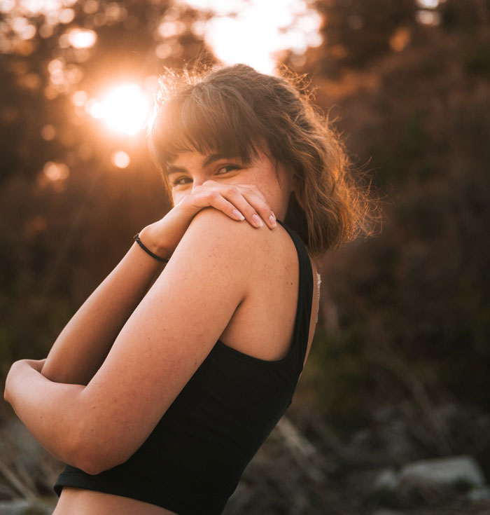 Happy woman standing outside 