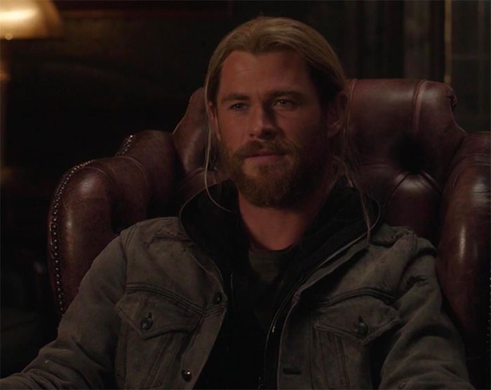 Thor is sitting in an armchair