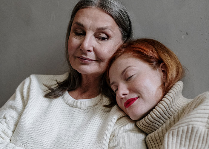 A mom and daughter in sweaters share an emotional moment together, reflecting on a tattoo-related ultimatum. A mom and daughter in sweaters share an emotional moment together, reflecting on a tattoo-related ultimatum.