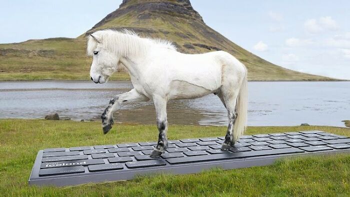 Icelandic horse stepping on a giant keyboard by a scenic landscape.