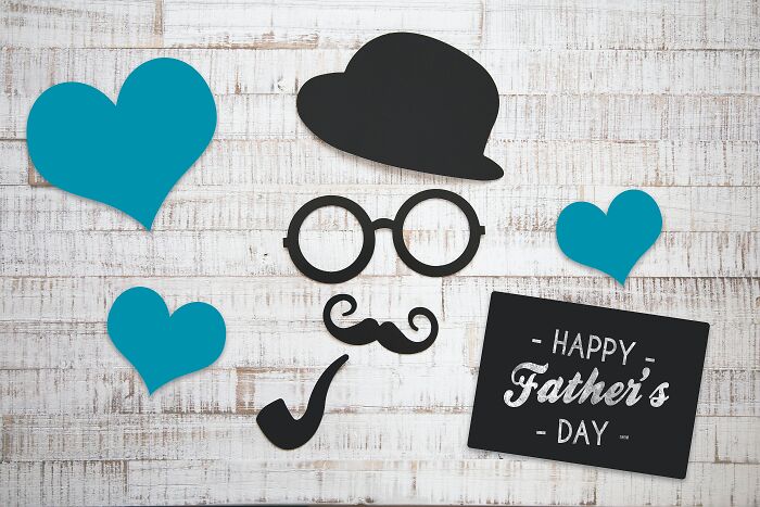 Blue paper hearts with black paper glasses, hat, mustache, pipe and happy birthday card