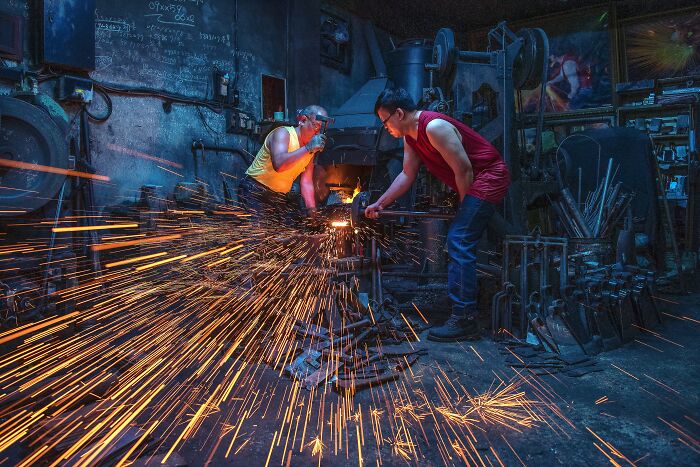 People Cutting Metal