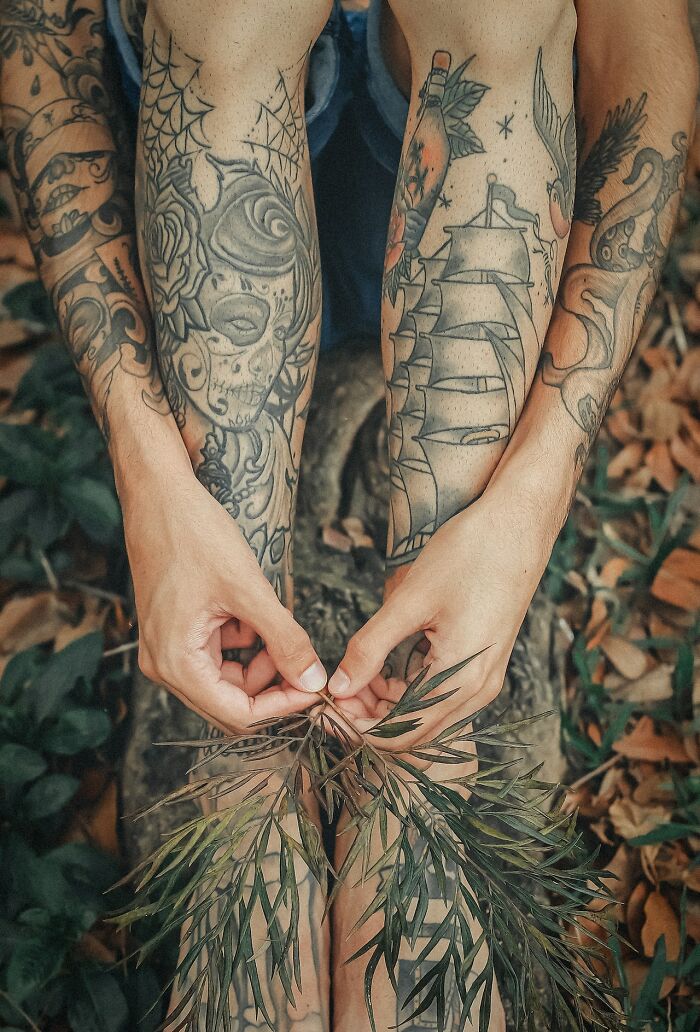 Tattooed arms with detailed black and gray ink designs, highlighting quality and craftsmanship people never buy cheap.