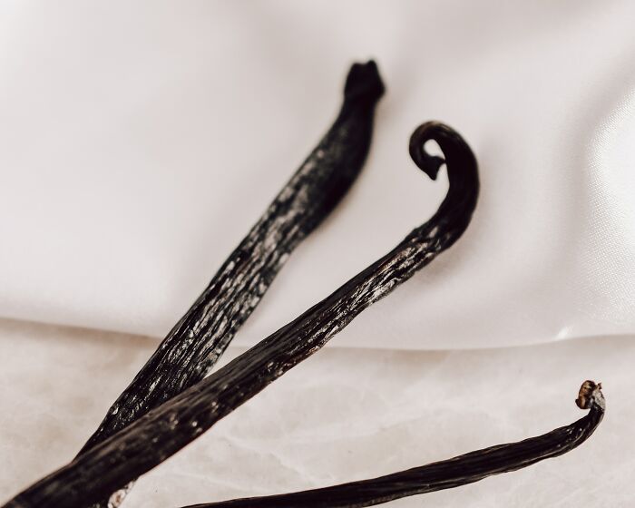 Three Vanilla Pods On Bed Sheet 