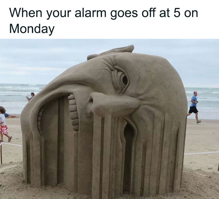 Sand sculpture depicting a melting face at the beach, illustrating a relatable Monday meme theme.