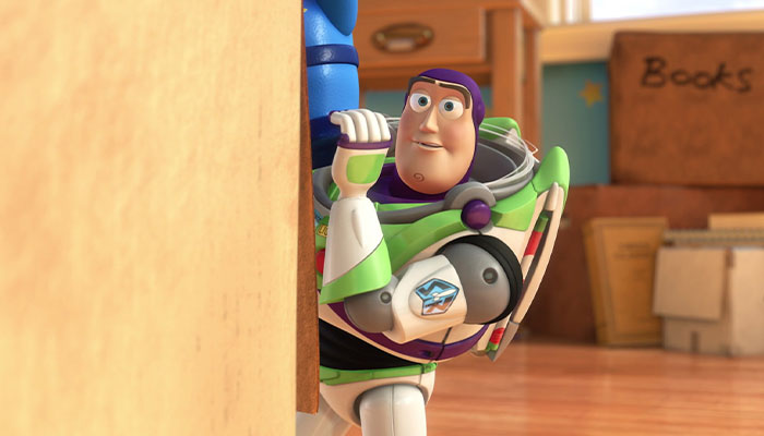 Buzz looking from behind a box