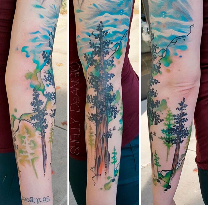 Colorful tree tattoos on forearm, depicting nature's wonders through vibrant designs.