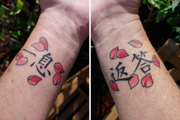 Wrist tattoo with Chinese characters and red rose petals.