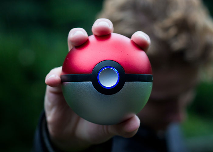 Person holding a red and white Pokeball toy, representing unique college courses you probably never knew existed.
